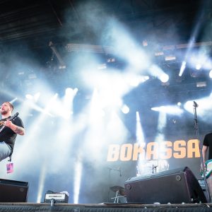Rock band performing live under colorful stage lighting
