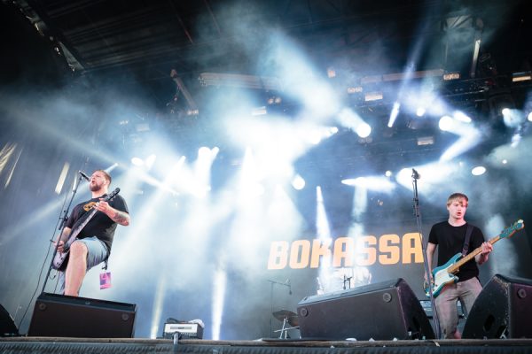 Rock band performing live under colorful stage lighting