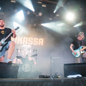 Rock guitarist performing live under stage lighting